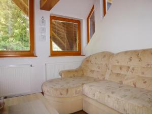 a living room with a couch and a window at Apartment Jalps 3 in beautiful Bohinjska Bistrica in Bohinj