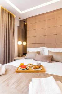 a hotel room with a tray of food on a bed at Sky Residence Split in Split