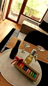 un tavolo in legno con vassoio di marcatori e bicchieri da vino di F&M Apartment No 18 a Skopje