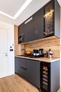 a kitchen with black cabinets and a counter top at Sky Residence Split in Split