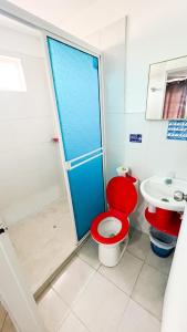 Un baño con un inodoro rojo y un lavabo. en Pretty View Posada, en San Andrés