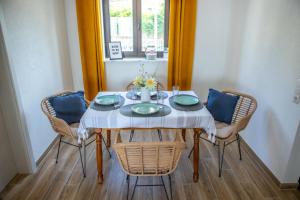 a dining room table with four chairs and a window at Ferienwohnung Marin - neu in Kastav