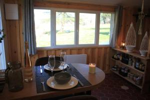 a dining room table with glasses and a candle at Gite charme et campagne in Montazeau