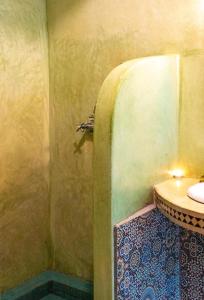 a bathroom with a shower with a sink in it at Riad Bianca Marrakech in Marrakesh