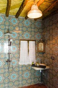 una camera con una parete ricoperta di carta da parati e una finestra di Riad Bianca Marrakech a Marrakech