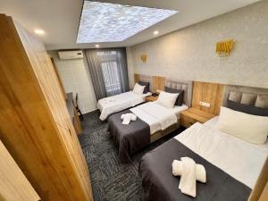 a hotel room with two beds and a skylight at Fengo Hotel & Spa in Trabzon