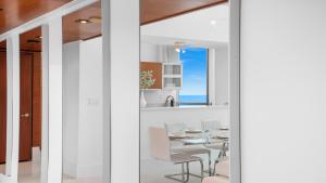 a dining room and kitchen with a table and chairs at Oceanview Private Townhouse at The Setai 1505-THB in Miami Beach