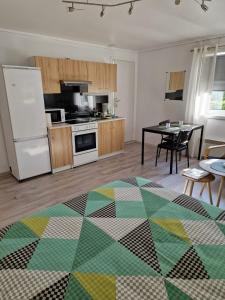 a living room with a kitchen and a table with chairs at Studio 4 in Dalen