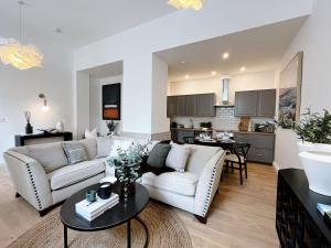 a living room with a couch and a table at Todmorden Town Centre Apartment in Todmorden