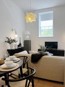 a living room with a couch and a table at Todmorden Town Centre Apartment in Todmorden