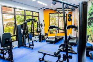a gym with several tread machines in a room at Apartamento 1912 World Vila Olímpia in Sao Paulo