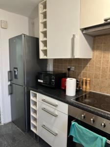 a kitchen with a refrigerator and a microwave at Shard room in London