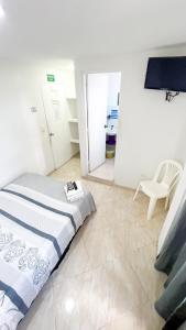 Un dormitorio con una cama y una silla dentro. en Pretty View Posada, en San Andrés