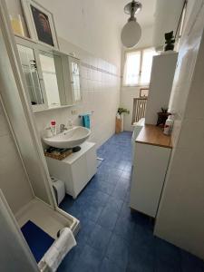 a bathroom with a white sink and a toilet at App di Myrò in Reggio Emilia