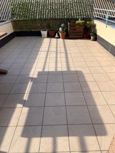 a shadow of a building on a patio at App di Myrò in Reggio Emilia