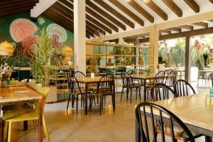 een eetkamer met tafels en stoelen in een restaurant bij Espectacular apartamento 200MB Wi-Fi, cerca al aeropuerto JMC in Marinilla