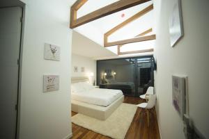 a bedroom with a white bed and a window at Rio Moment's in Castelo de Paiva +79 photos