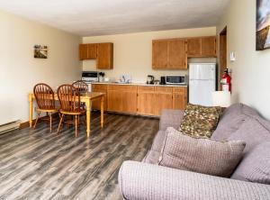 a living room with a couch and a table at Hebridean Motel in Port Hood