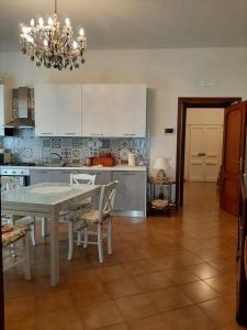 a kitchen with a table and a dining room at Casa Ricordi in Vietri sul Mare +23 photos