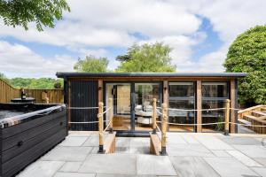 a small cabin with glass doors on a patio at The Pod at Avonwood House 
