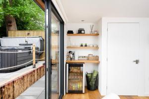 a kitchen with a sliding glass door and a patio at The Pod at Avonwood House 