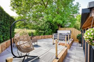 a patio with a chair and a grill at The Pod at Avonwood House 