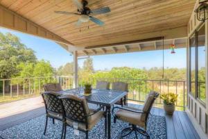 patio con mesa y sillas y ventilador de techo en Spacious home with pool, bar, game room, parking, on 5 private acres., en Oroville