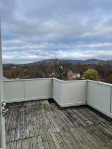 a balcony with a white fence and a view at Frognervein Terrace Penthouse in Oslo