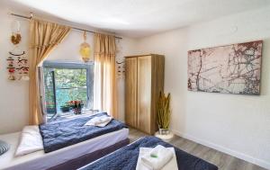 a bedroom with two beds and a window at B&B Veronika in Bakar