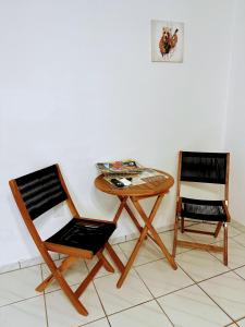 two chairs and a wooden table and a table and a chair at lovely apartment with free parking in Miami