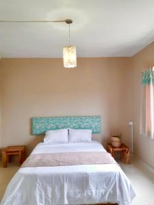 a bedroom with a large bed with a blue headboard at Just Chill Villa in Trou aux Biches