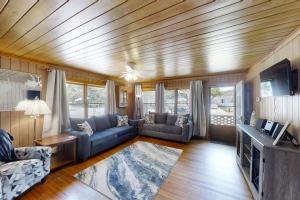 a living room with a couch and a tv at The Little Brick Cottage in Myrtle Beach