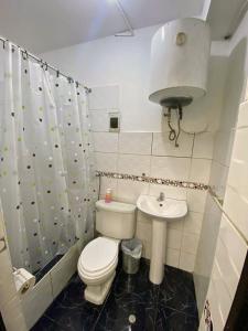 a small bathroom with a toilet and a sink at Casa Campestre El Huerto in Ricardo Palma