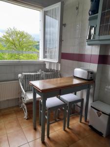 a table and chairs in a kitchen with a window at Amplio piso muy luminoso y con vistas in Laredo +17 photos