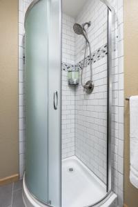 a shower with a glass door in a bathroom at Little House in the Big Woods in Forest Ranch