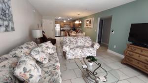 a living room with a couch and a tv at 2BR / 2BA Apartment Sienna Park. in Sarasota