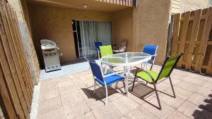 a patio with a table and chairs on a patio at 2BR / 2BA Apartment Sienna Park. in Sarasota
