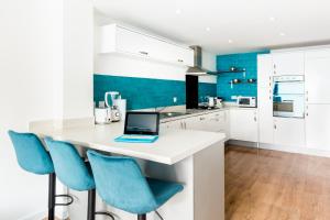a kitchen with a desk with a laptop on it at Spacious Group House for Contractors & Families - Ensuites, Parking & Netflix by DreamyPads in Bristol