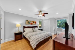 a bedroom with a bed and a ceiling fan at 1303 Pelican Watch Villa in Seabrook Island