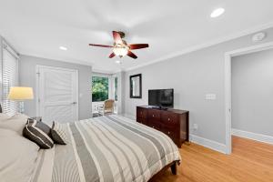 a bedroom with a bed and a ceiling fan at 1303 Pelican Watch Villa in Seabrook Island