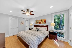a bedroom with a bed and a ceiling fan at 1303 Pelican Watch Villa in Seabrook Island
