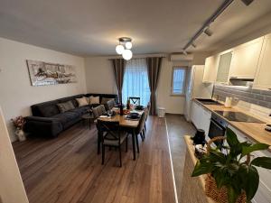 a kitchen and living room with a table and a couch at Sweet House MARCELLA in Imotski