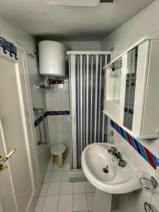 y baño pequeño con lavabo y ducha. en LA TERRAZZA SUL MARE, en Porto Empedocle
