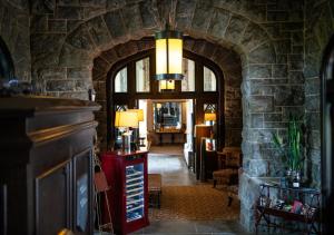 a hallway with an archway in a stone building at Castle Hotel & Spa in Tarrytown