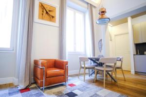 a living room with a chair and a table at Dolcevita Boutique Apartment in Florence