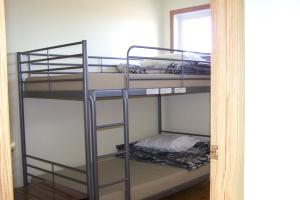 a room with three bunk beds in a room at HI Rossburn 9 Finger Ranch in Rossburn