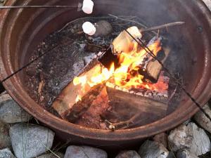 a fire in a pot with flames in it at HI Rossburn 9 Finger Ranch in Rossburn