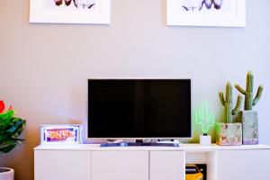a tv sitting on top of a white cabinet at Dolcevita Boutique Apartment in Florence