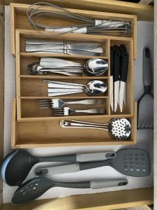 a drawer full of utensils in a wooden box at Home from Home 5 bedroom villa in Davenport