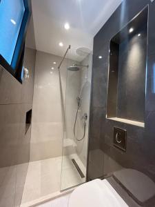 a bathroom with a shower with a glass door at Perla apartmani in Petrovac na Moru